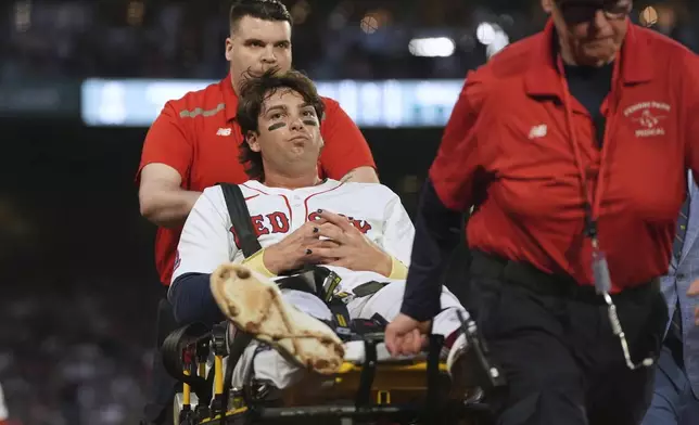 Boston Red Sox's Triston Casas is transported off the field on a stretcher after an apparent injury during the second inning of a baseball game against the Minnesota Twins at Fenway Park, Friday, May 2, 2025, in Boston. (AP Photo/Charles Krupa)
