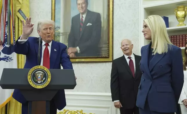 President Donald Trump, left, gestures as Attorney Genera, Pam Bondi, right, looks on during a swearing in ceremony for interim U.S. Attorney General for the District of Columbia Jeanine Pirro, Wednesday, May 28, 2025, in the Oval Office of the Whit House in Washington. (AP Photo/Evan Vucci)