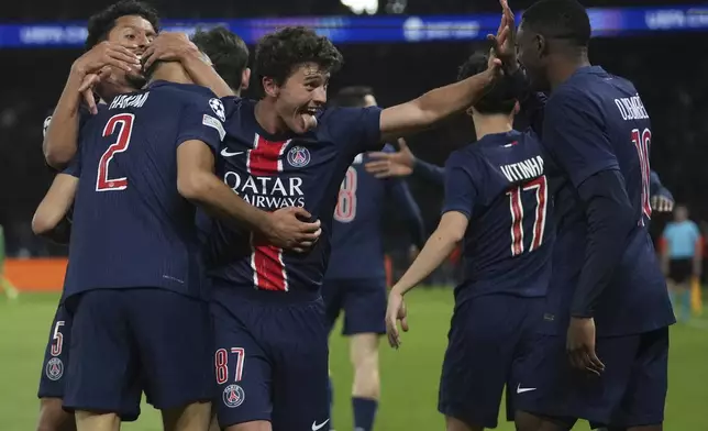 PSG's Achraf Hakimi, left, celebrates with teammates after scoring his sides second goal during the Champions League semifinal, second leg soccer match between Paris Saint-Germain and Arsenal at the Parc des Princes in Paris, Wednesday, May 7, 2025. (AP Photo/Thibault Camus)