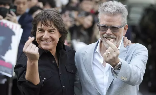 Actor Tom Cruise, left, and director Christopher McQuarrie pose for the photographers upon their arrival to promote their latest movie "Mission: Impossible - The Final Reckoning," at the Gimpo Airport in Seoul, South Korea, Wednesday, May 7, 2025. (AP Photo/Lee Jin-man)