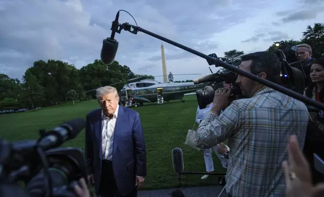 President Donald Trump speaks with reporters after disembarking Marine One upon arrival on the South Lawn of the White House in Washington, Sunday, May 4, 2025. (AP Photo/Rod Lamkey, Jr.)