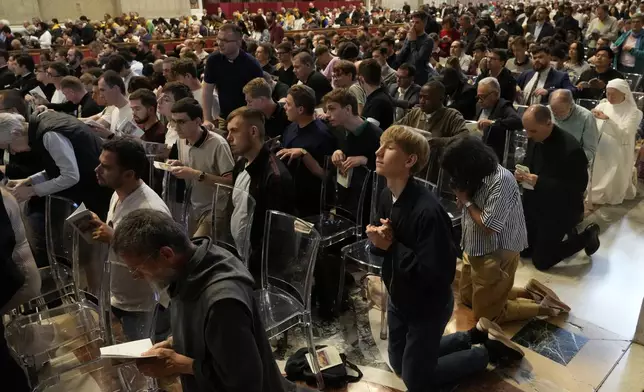 Faithful kneel during a final Mass celebrated by cardinals inside St. Peter's Basilica, before the conclave to elect a new pope, at the Vatican, Wednesday, May 7, 2025. (AP Photo/Gregorio Borgia)