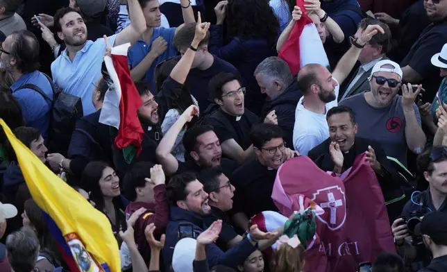 People react as white smoke billows from the chimney of the Sistine Chapel where 133 cardinals are gathering on the second day of the conclave to elect a successor to late Pope Francis, at the Vatican, Thursday, May 8, 2025. (AP Photo/Luca Bruno)