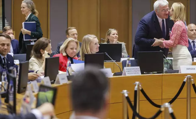 Ukraine's Foreign Minister Andrii Sybiha, second right, is greeted by European Union foreign policy chief Kaja Kallas during a meeting of EU foreign ministers at the European Council building in Brussels, Belgium, Tuesday, May 20, 2025. (Olivier Matthys, Pool Photo via AP)