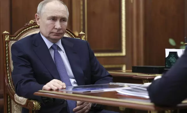 Russian President Vladimir Putin listens to Promsvyazbank CEO Pyotr Fradkov during their meeting at the Kremlin in Moscow, Russia, on Thursday, May 15, 2025. (Alexander Kryazhev, Sputnik, Kremlin Pool Photo via AP)