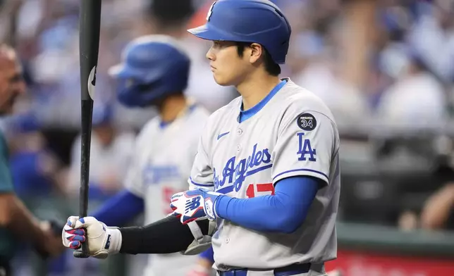 Los Angeles Dodgers designated hitter Shohei Ohtani, of Japan, waits to bat against the Arizona Diamondbacks prior to a baseball game Thursday, May 8, 2025, in Phoenix. (AP Photo/Ross D. Franklin)