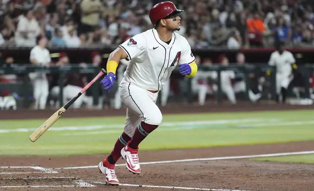 Arizona Diamondbacks' Gabriel Moreno watches the flight of his grand slam against the Los Angeles Dodgers during the fourth inning of a baseball game Thursday, May 8, 2025, in Phoenix. (AP Photo/Ross D. Franklin)