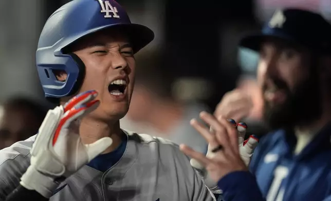 Los Angeles Dodgers two-way player Shohei Ohtani (17) celebrates his solo homer against the Atlanta Braves in the third inning of a baseball game, Saturday, May 3, 2025, in Atlanta. (AP Photo/Mike Stewart)
