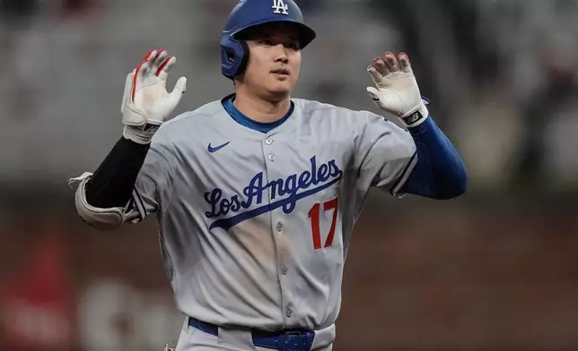 Los Angeles Dodgers two-way player Shohei Ohtani (17) celebrates his solo homer against the Atlanta Braves in the third inning of a baseball game, Saturday, May 3, 2025, in Atlanta. (AP Photo/Mike Stewart)