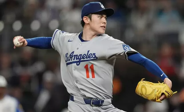 Los Angeles Dodgers pitcher Roki Sasaki (11) delivers against the Atlanta Braves in the second inning of a baseball game, Saturday, May 3, 2025, in Atlanta. (AP Photo/Mike Stewart)