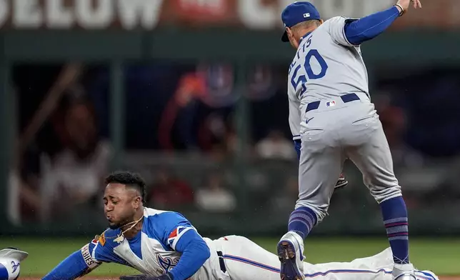 Atlanta Braves' Ozzie Albies (1) steals second base against Los Angeles Dodgers shortstop Mookie Betts (50) in the second inning of a baseball game, Saturday, May 3, 2025, in Atlanta. (AP Photo/Mike Stewart)