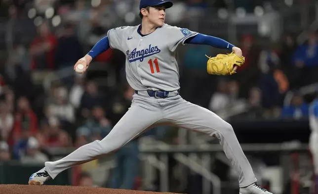 Los Angeles Dodgers pitcher Roki Sasaki (11) delivers against the Atlanta Braves in the first inning of a baseball game, Saturday, May 3, 2025, in Atlanta. (AP Photo/Mike Stewart)