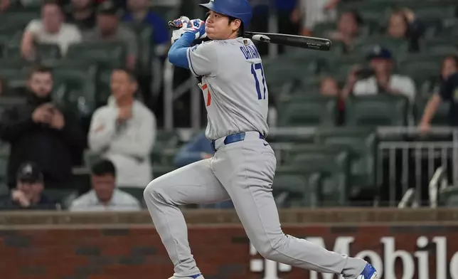 Los Angeles Dodgers two-way player Shohei Ohtani (17) hits a single against the Atlanta Braves in the first inning of a baseball game, Saturday, May 3, 2025, in Atlanta. (AP Photo/Mike Stewart)