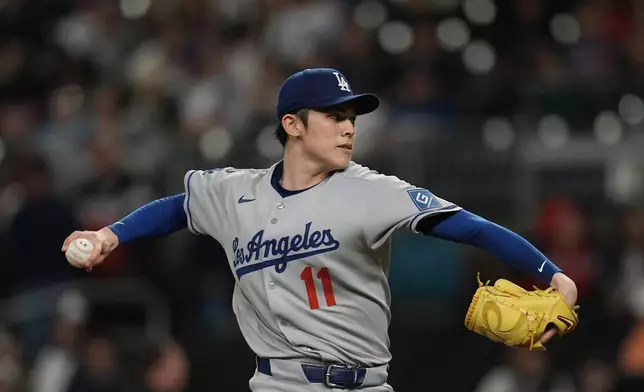 Los Angeles Dodgers pitcher Roki Sasaki (11) delivers against the Atlanta Braves in the first inning of a baseball game, Saturday, May 3, 2025, in Atlanta. (AP Photo/Mike Stewart)