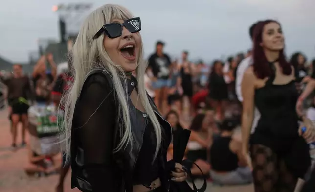 A fan waits for the start of Lady Gaga's free concert on Copacabana beach in Rio de Janeiro, Saturday, May 3, 2025. (AP Photo/Bruna Prado)