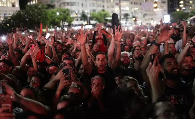 Fans cheer as they watch Lady Gaga rehearse a day ahead of her free concert, on Copacabana beach, in Rio de Janeiro, Friday, May 2, 2025. (AP Photo/Bruna Prado)