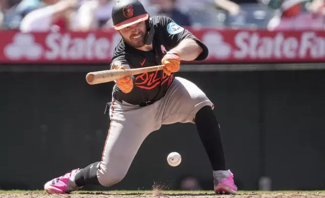 Baltimore Orioles' Maverick Handley bunts during the sixth inning of a baseball game against the Los Angeles Angels, Sunday, May 11, 2025, in Anaheim, Calif. (AP Photo/Eric Thayer)
