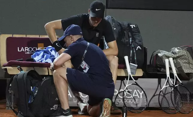 Italy's Jannik Sinner is treated during a medical time out, during a round of sixteen match against Argentina's Francisco Cerundolo at the Italian Open tennis tournament in Rome, Tuesday, May 13, 2025. (AP Photo/Andrew Medichini)