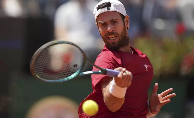 Russia's Karen Khachanov returns a shot during a round of sixteen match against Spain's Carlos Alcaraz at the Italian Open tennis tournament in Rome, Tuesday, May 13, 2025. (AP Photo/Andrew Medichini)