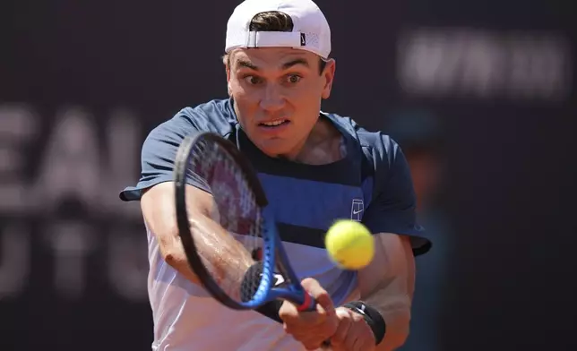 Britain's Jack Draper returns a shot during a round of sixteen match against France's Corentin Moutet at the Italian Open tennis tournament in Rome, Tuesday, May 13, 2025. (AP Photo/Andrew Medichini)