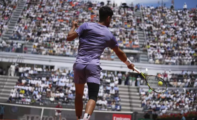 Spain's Carlos Alcaraz returns a shot during a round of sixteen match against Russia's Karen Khachanov at the Italian Open tennis tournament in Rome, Tuesday, May 13, 2025. (AP Photo/Andrew Medichini)