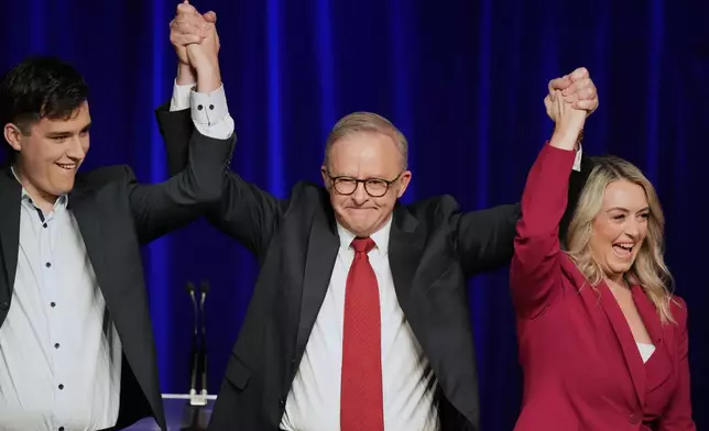Australian Prime Minister Anthony Albanese, his son Nathan and partner Jodie Haydon react as they meet the party faithful after winning a second term following the general election in Sydney, Saturday, May 3, 2025. (AP Photo/Rick Rycroft)