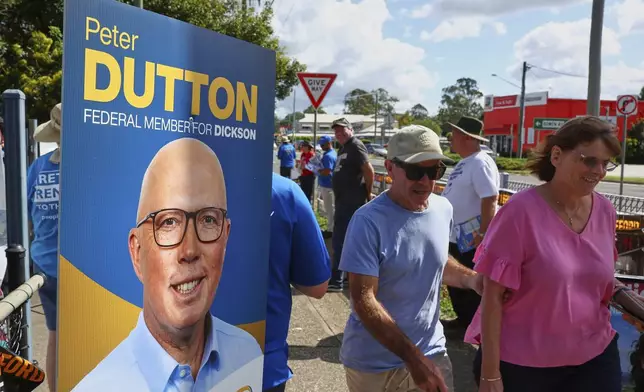 People arrive at a polling booth in Brisbane, Australia, Saturday, May 3, 2025. (AP Photo/Pat Hoelscher)