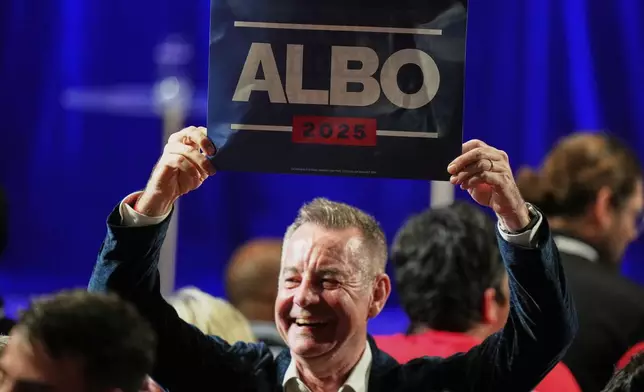 A Labor Party supporter reacts as he watches results shown on a screen at their party headquarters in Sydney, Saturday, May 3, 2025. (AP Photo/Rick Rycroft)
