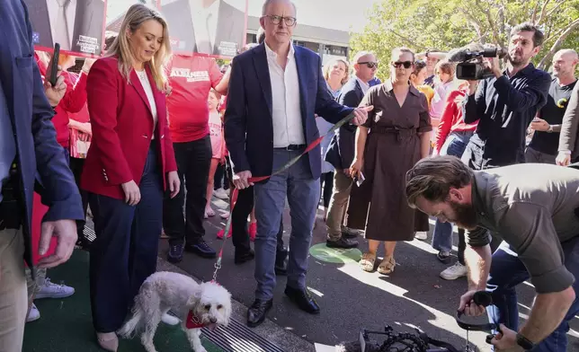 Australian Prime Minister Anthony Albanese and his partner Jodie Haydon arrive at a polling booth to vote in his electorate in Sydney, Saturday, May 3, 2025. (AP Photo/Rick Rycroft)