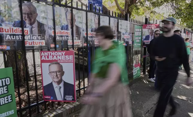 People arrive to vote at a polling booth in Prime Minister Anthony Albanese's electorate in Sydney, Saturday, May 3, 2025. (AP Photo/Rick Rycroft)