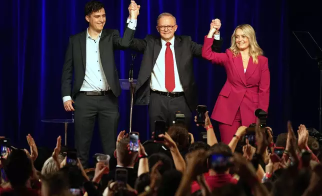 Australian Prime Minister Anthony Albanese, his son Nathan and partner Jodie Haydon react as they meet the party faithful after winning a second term following the general election in Sydney, Saturday, May 3, 2025. (AP Photo/Rick Rycroft)