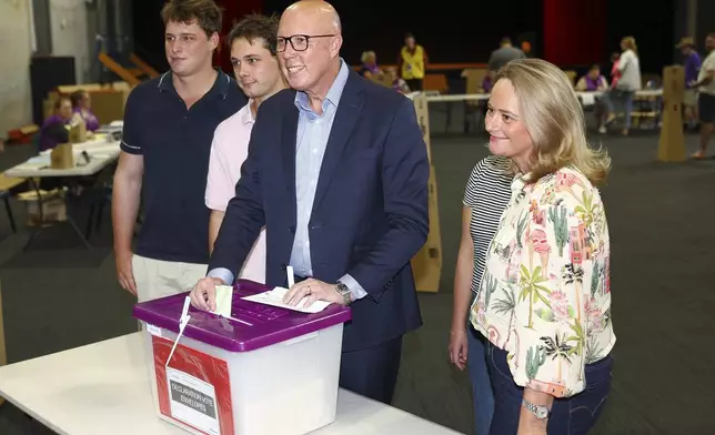 Australian Liberal Party leader Peter Dutton stands with his sons, Tom and Harry and his wife Kirilly as he votes in his electorate in Brisbane, Australia, Saturday, May 3, 2025. (AP Photo/Pat Hoelscher)