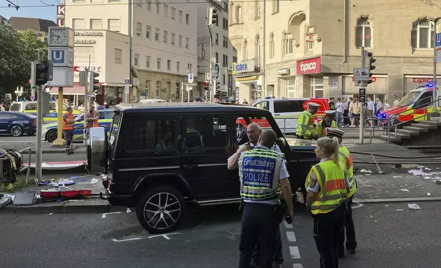 Police work at the scene where a vehicle collided into a group of people in Stuttgart, Germany, on Friday, May 2, 2025. (Marco Krefting/dpa via AP)