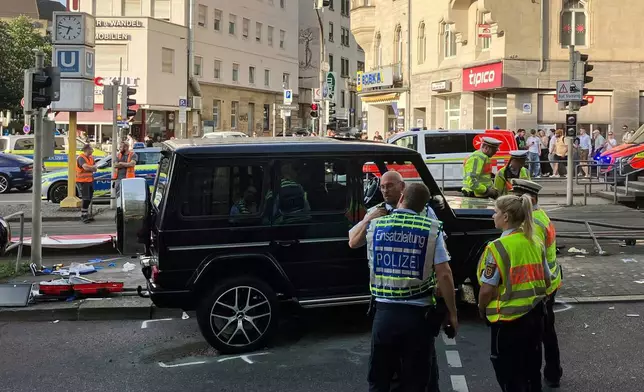 Police work at the scene where a vehicle collided into a group of people in Stuttgart, Germany, on Friday, May 2, 2025. (Marco Krefting/dpa via AP)