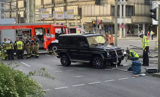 Police work at the scene where a vehicle collided into a group of people in Stuttgart, Germany, on Friday, May 2, 2025. (Marco Krefting/dpa via AP)