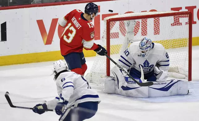 Florida Panthers center Sam Reinhart (13) shoots against Toronto Maple Leafs goaltender Joseph Woll (60) during the first period of Game 4 of a second-round NHL hockey playoff series, Sunday, May 11, 2025, in Sunrise, Fla. (AP Photo/Michael Laughlin)