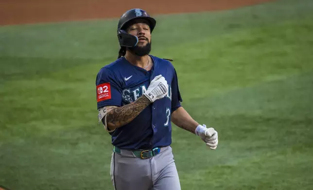 Seattle Mariners' J.P. Crawford reacts after hitting a solo home run during the first inning of a baseball game against the Texas Rangers, Saturday, May 3, 2025, in Arlington, Texas. (AP Photo/Jessica Tobias)