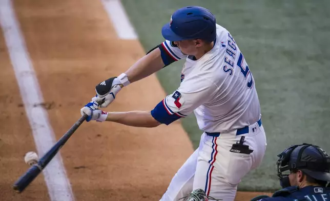 Texas Rangers' Corey Seager bats against the Seattle Mariners during the first inning of a baseball game Saturday, May 3, 2025, in Arlington, Texas. (AP Photo/Jessica Tobias)