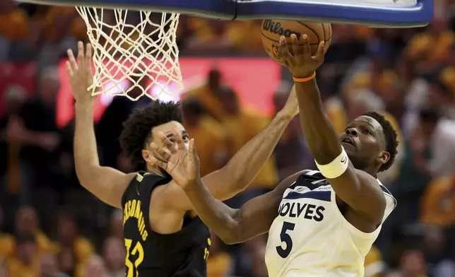 Minnesota Timberwolves guard Anthony Edwards (5) shoots against Golden State Warriors forward Trayce Jackson-Davis (32) during the first half of Game 4 in the Western Conference semifinals of the NBA basketball playoffs Monday, May 12, 2025, in San Francisco. (AP Photo/Jed Jacobsohn)