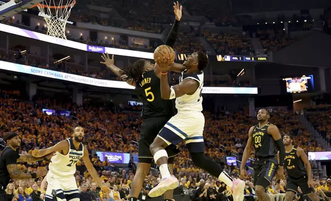 Minnesota Timberwolves guard Anthony Edwards, center right, looks to shoot against Golden State Warriors forward Kevon Looney, center left, during the first half of Game 4 in the Western Conference semifinals of the NBA basketball playoffs Monday, May 12, 2025, in San Francisco. (AP Photo/Jed Jacobsohn)