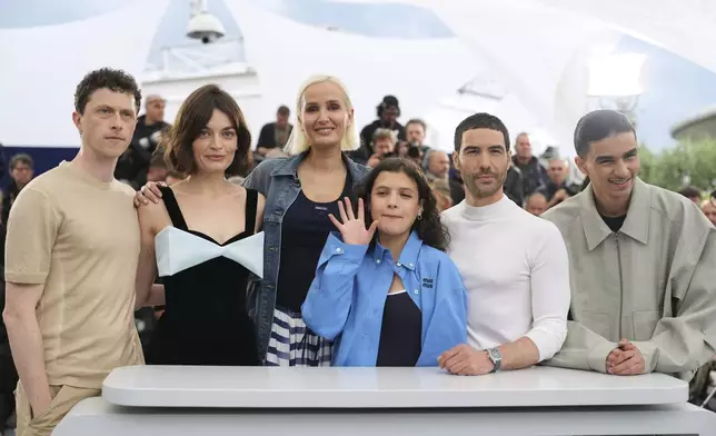 Finnegan Oldfield, from left, Emma Mackey, director Julia Ducournau, Melissa Boros, Tahar Rahim and Louai El Amrousy pose for photographers at the photo call for the film 'Alpha' at the 78th international film festival, Cannes, southern France, Tuesday, May 20, 2025. (AP Photo/Natacha Pisarenko)