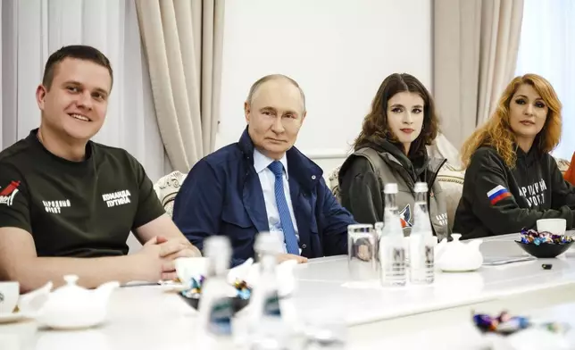 In this photo released by the Russian Presidential Press Service on Wednesday, May 21, 2025, Russian President Vladimir Putin, 2nd left, attends a meeting with volunteers at Kursk region, Russia. (Russian Presidential Press Service via AP)