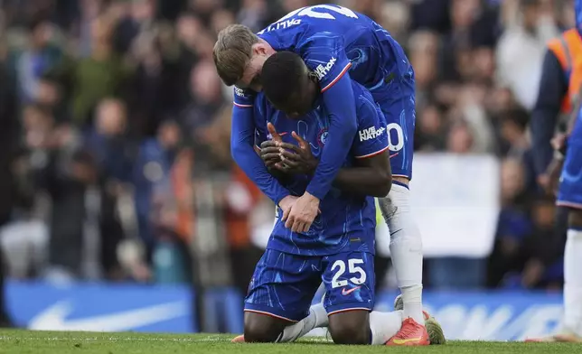 Chelsea's Moises Caicedo, bottom, and Cole Palmer celebrate at the end of the English Premier League soccer match between Chelsea and Liverpool at Stamford Bridge stadium in London, Sunday, May 4, 2025. (AP Photo/Kin Cheung)