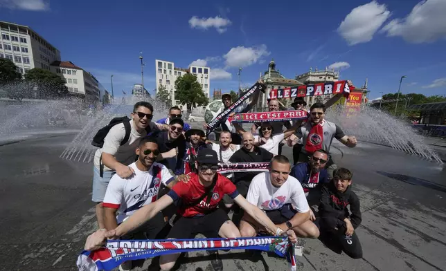 PSG fans cheer in downtown ahead of the Champions League final soccer match between Paris Saint-Germain and Inter Milan in Munich, Germany, Friday, May 30, 2025. (AP Photo/Luca Bruno)