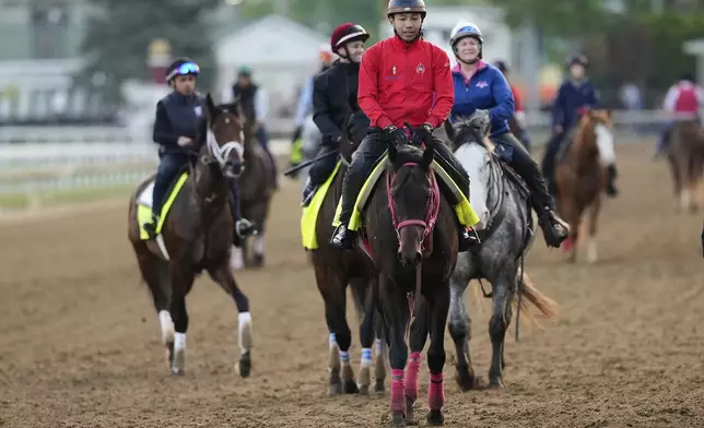 Kentucky Derby hopefuls work out led by Japanese horse Admire Daytona, front, at Churchill Downs Monday, April 28, 2025, in Louisville, Ky. (AP Photo/Charlie Riedel)