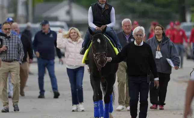 Kentucky Derby entrant Rodriguez is led to the track by trainer Bob Baffort for a workout at Churchill Downs Tuesday, April 29, 2025, in Louisville, Ky. (AP Photo/Charlie Riedel)