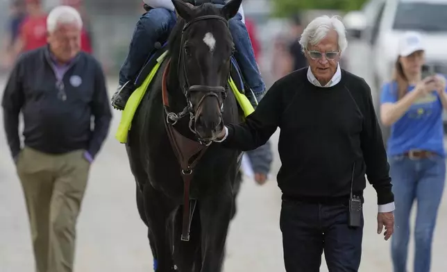 Kentucky Derby entrant Rodriguez is led to the track by trainer Bob Baffort for a workout at Churchill Downs Tuesday, April 29, 2025, in Louisville, Ky. (AP Photo/Charlie Riedel)