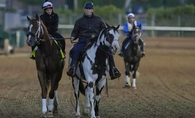 Kentucky Derby entrant American Promise is lead off the track by trainer D. Wayne Lukas after a workout at Churchill Downs Monday, April 28, 2025, in Louisville, Ky. (AP Photo/Charlie Riedel)