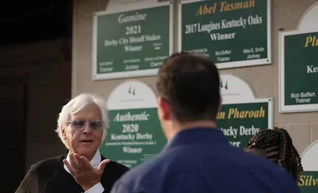 Trainer Bob Baffert talks to visitors outside his barn at Churchill Downs Tuesday, April 29, 2025, in Louisville, Ky. (AP Photo/Charlie Riedel)