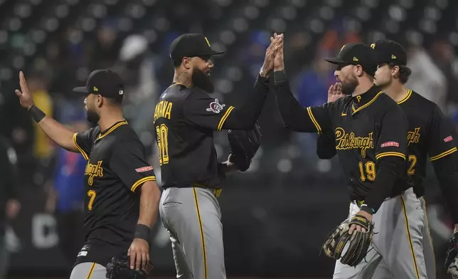 Pittsburgh Pirates pitcher Dennis Santana (60) celebrates with Jared Triolo (19) and Isiah Kiner-Falefa (7) after a baseball game against the New York Mets Wednesday, May 14, 2025, in New York. (AP Photo/Frank Franklin II)